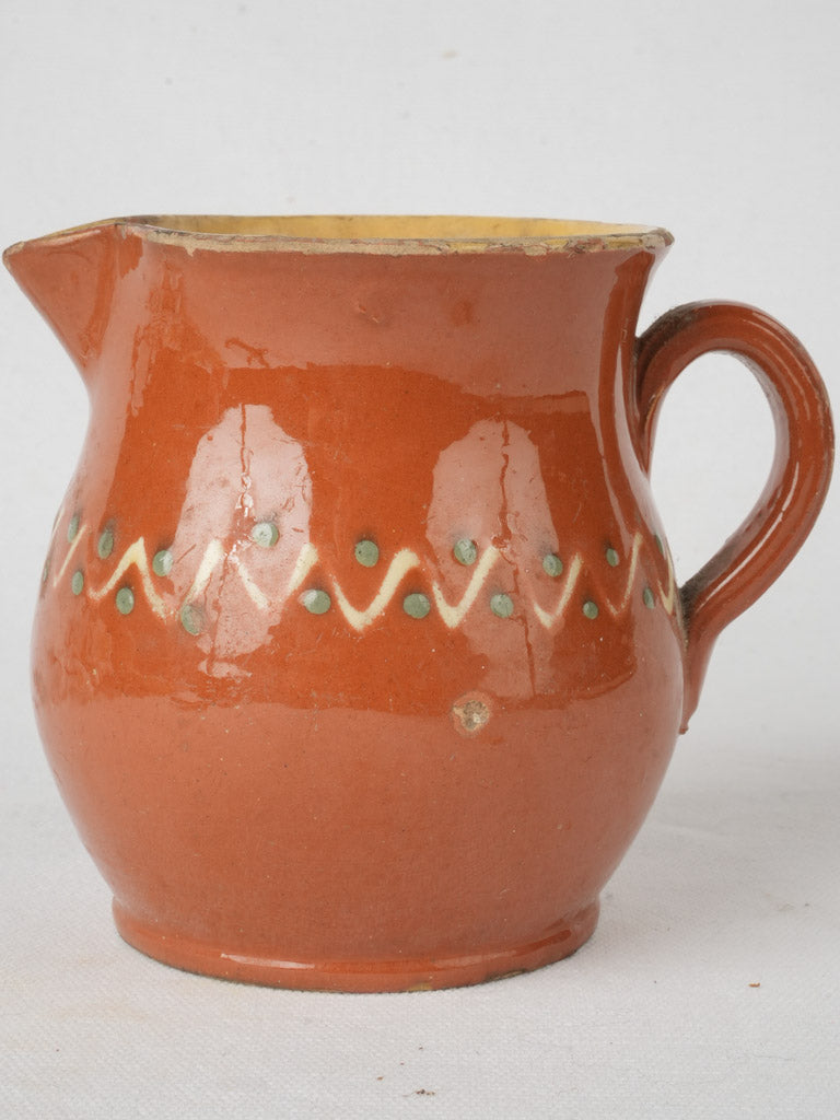 Traditional red-orange pottery creamer