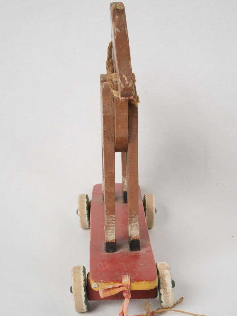 Timeworn retro horse toy with wheels