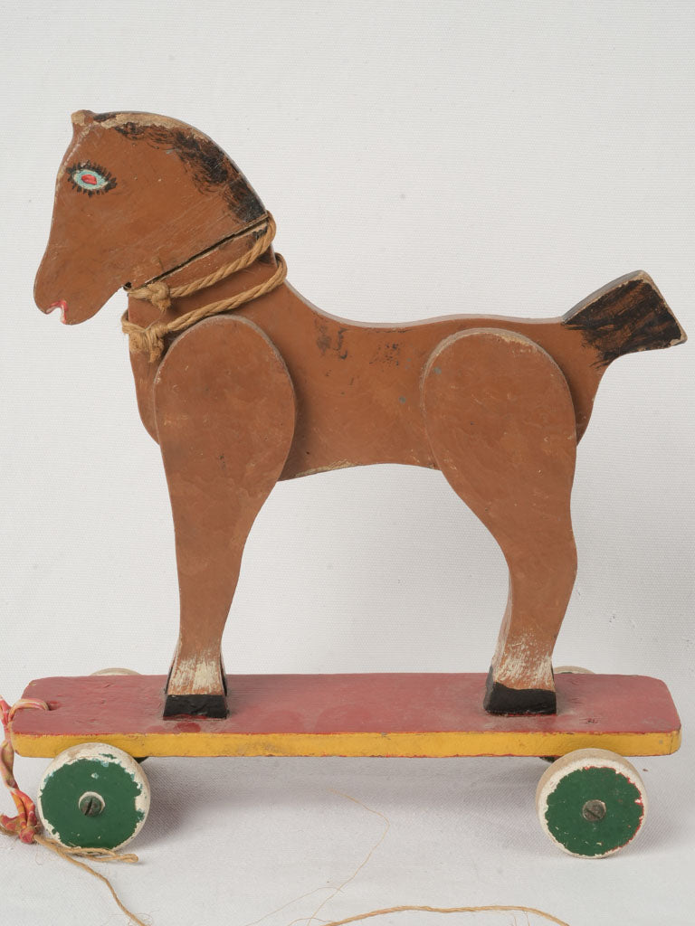 Antique green-wheeled wooden pull-horse