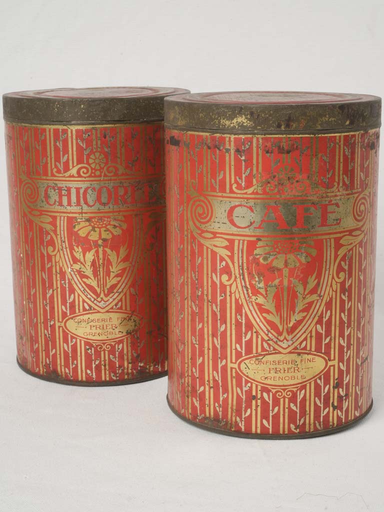 Antique ornate red tin canisters  