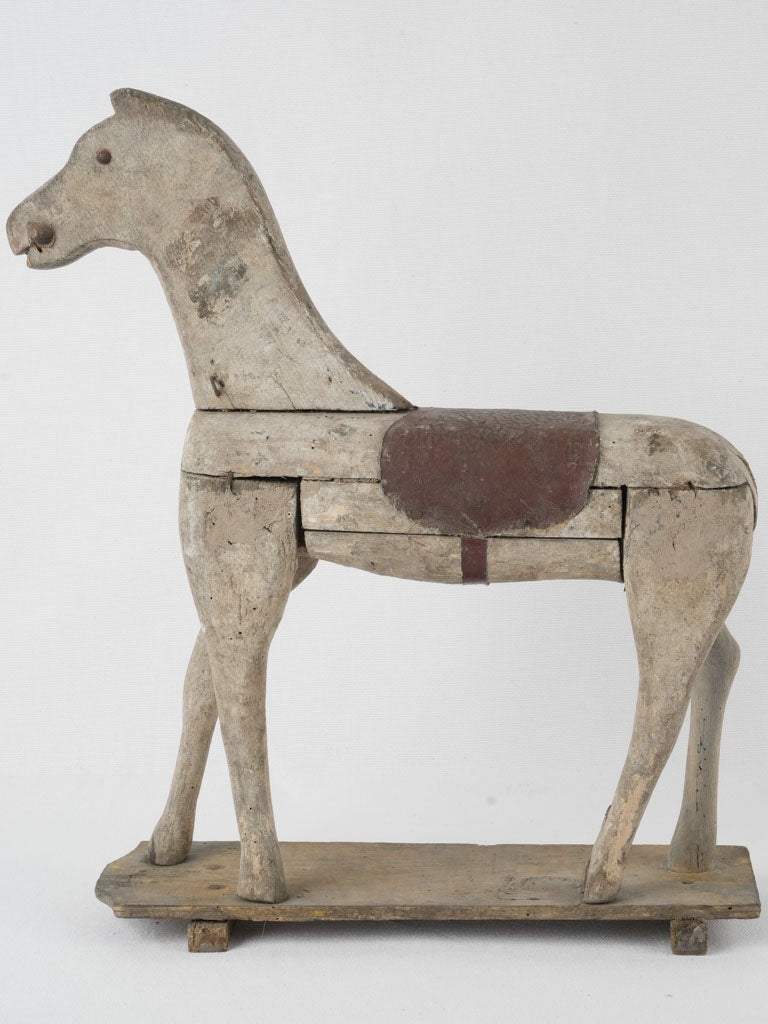 Aged, handcrafted French wooden horse toy