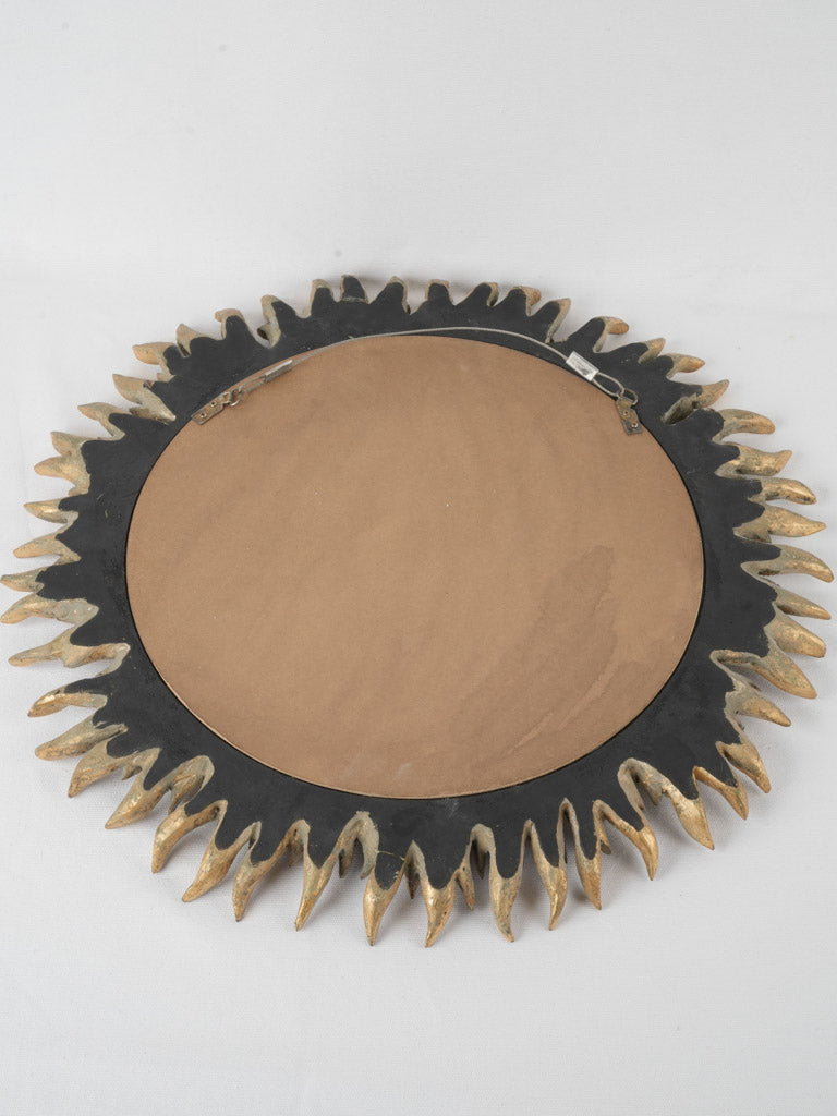 Elegant sunburst mirror, evocative flame-petal design