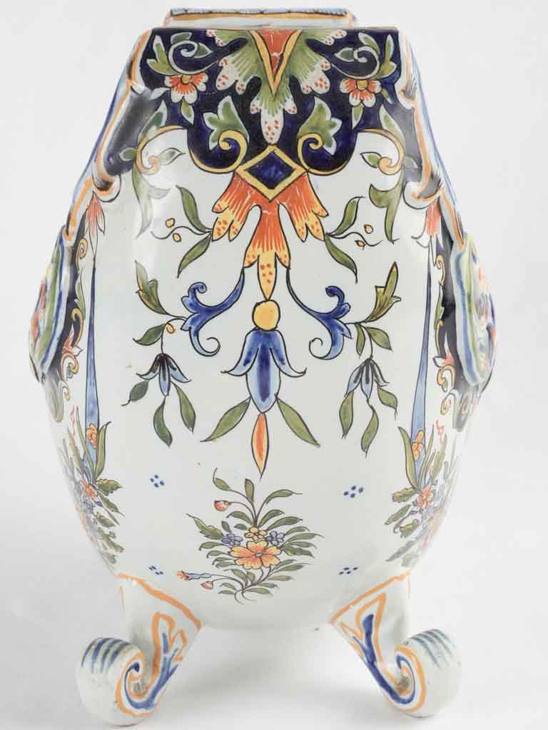 Crescentshaped ornate earthenware scroll-footed pot