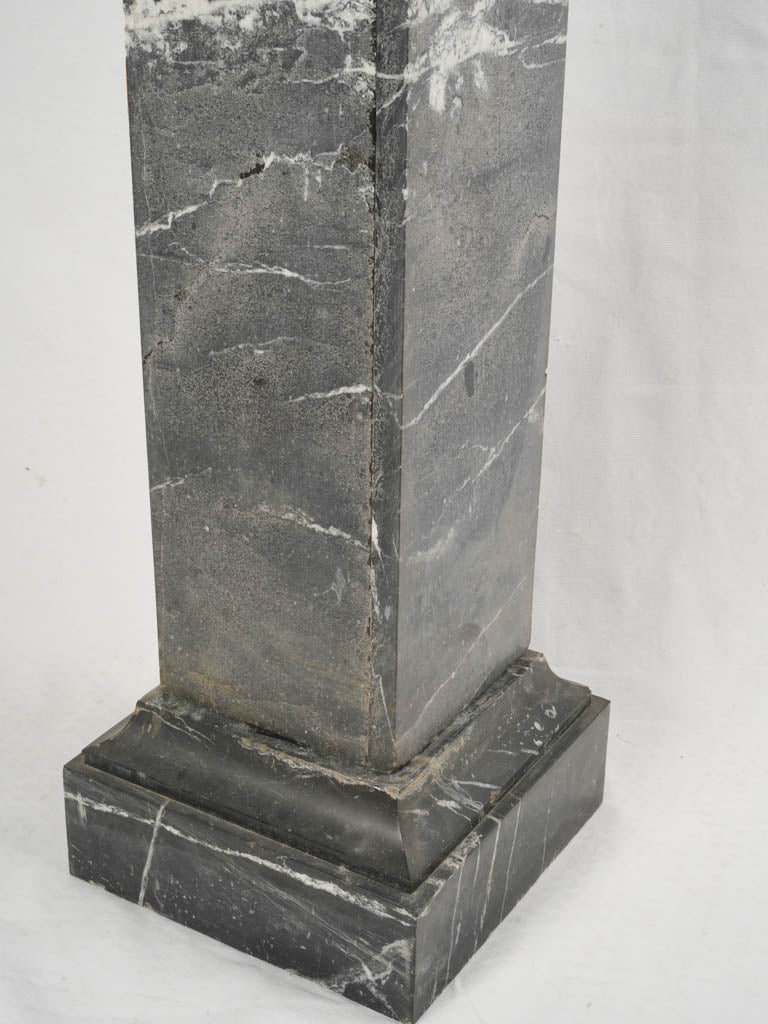 Dark veined marble pedestal column  