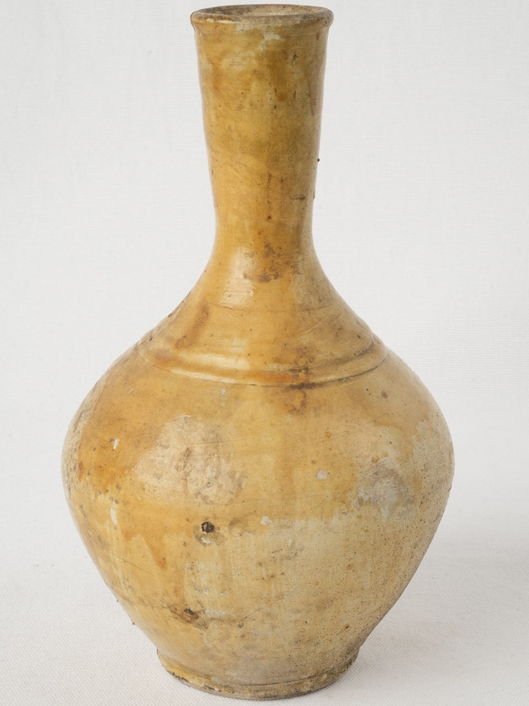 Warm yellow glazed pottery bottle  