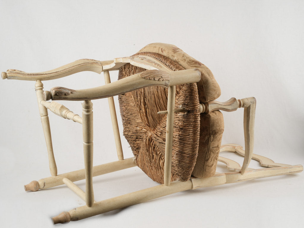 Time-worn ladderback straw-seat armchair