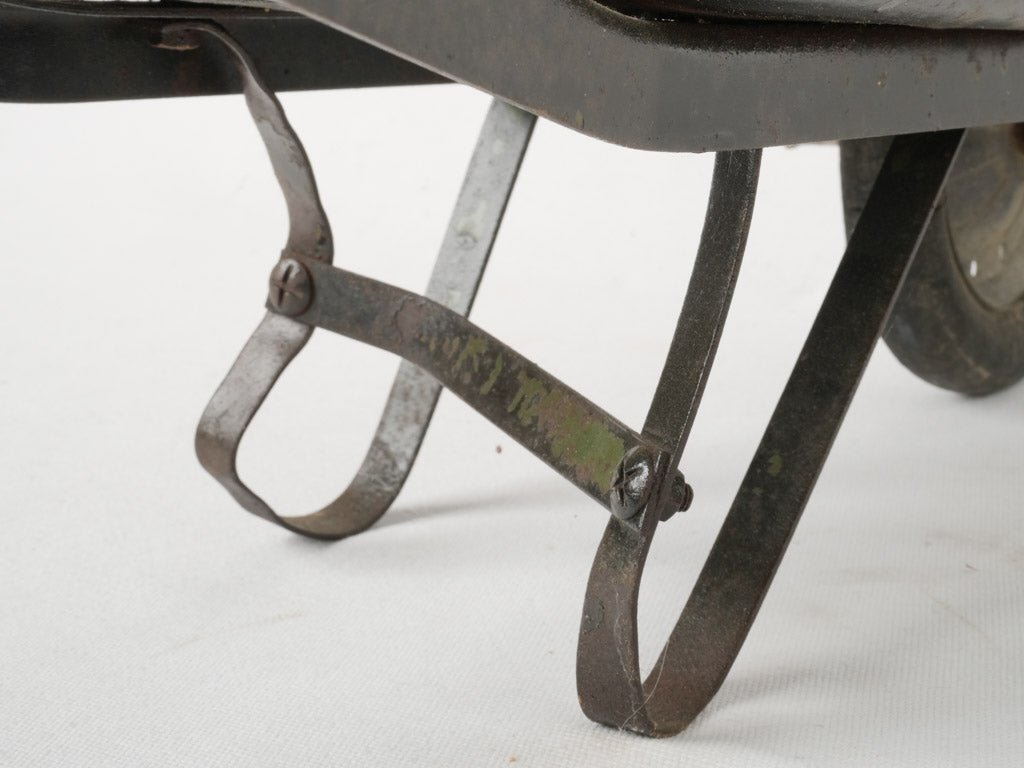 Rustic black French metal wheelbarrow