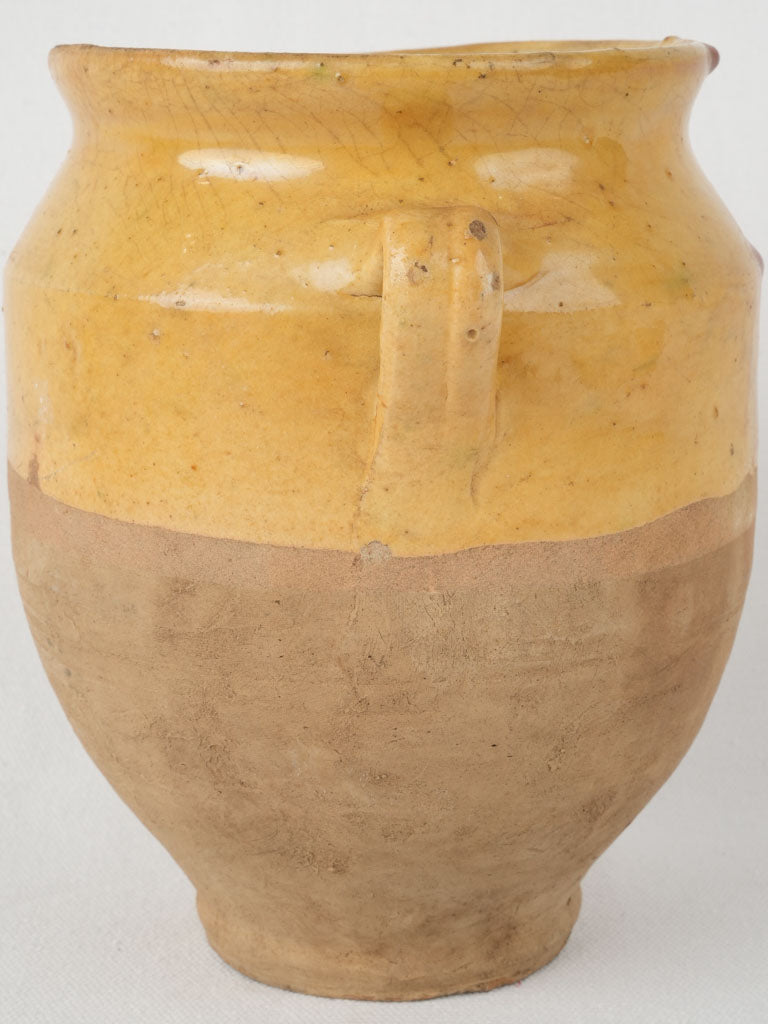 Vintage, artisan-crafted, yellow-glazed confit vessel