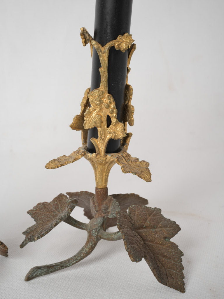 Aged bronze candlesticks with vine decoration