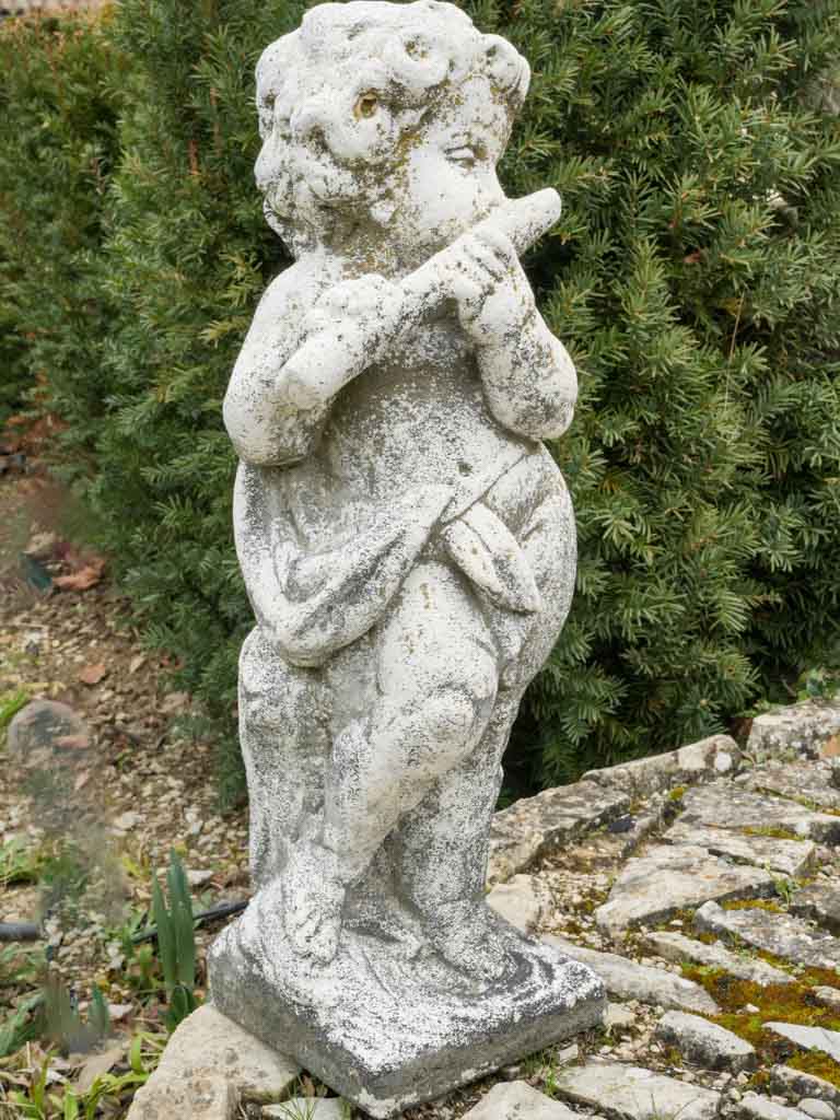 Patinated cherub playing flute ornament