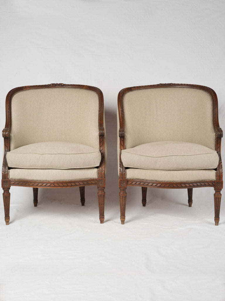 Restored, upholstered walnut armchairs