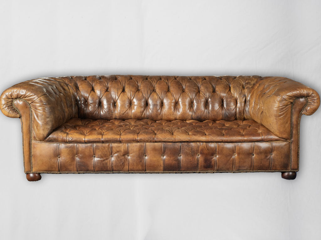 Classic English pub-sourced brown leather sofas