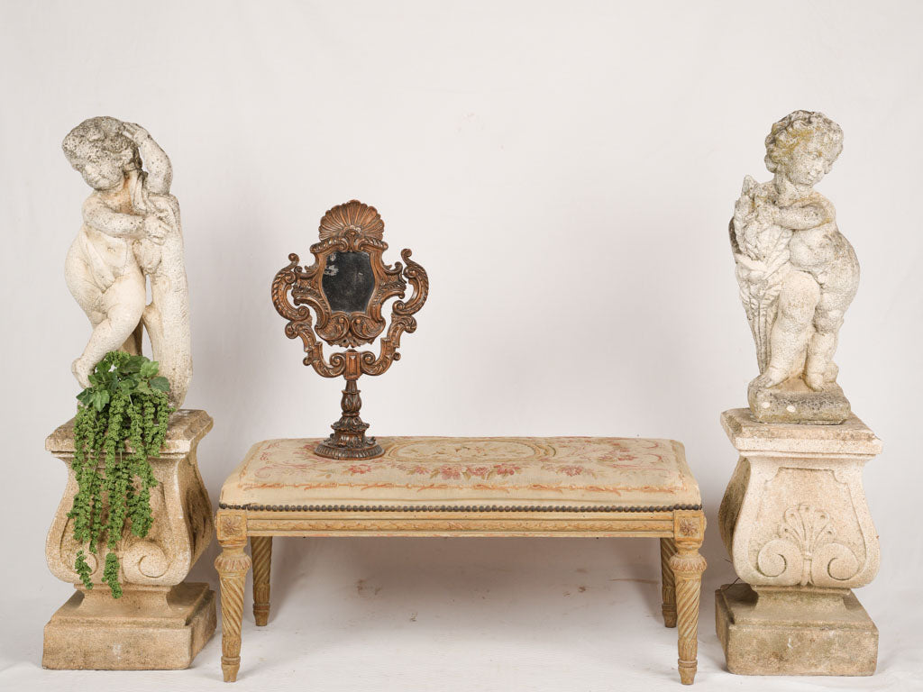 Aged antique garden cherub figurines