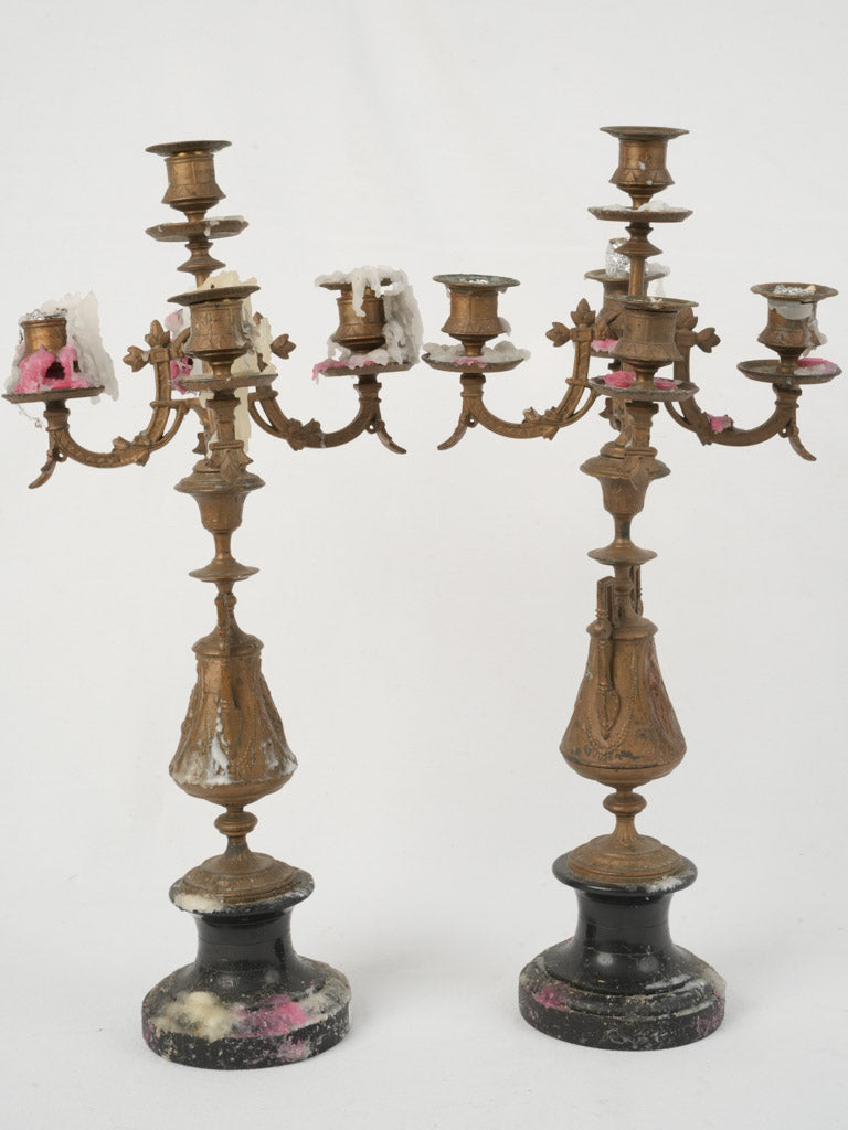 Aged ornate metal candelabras