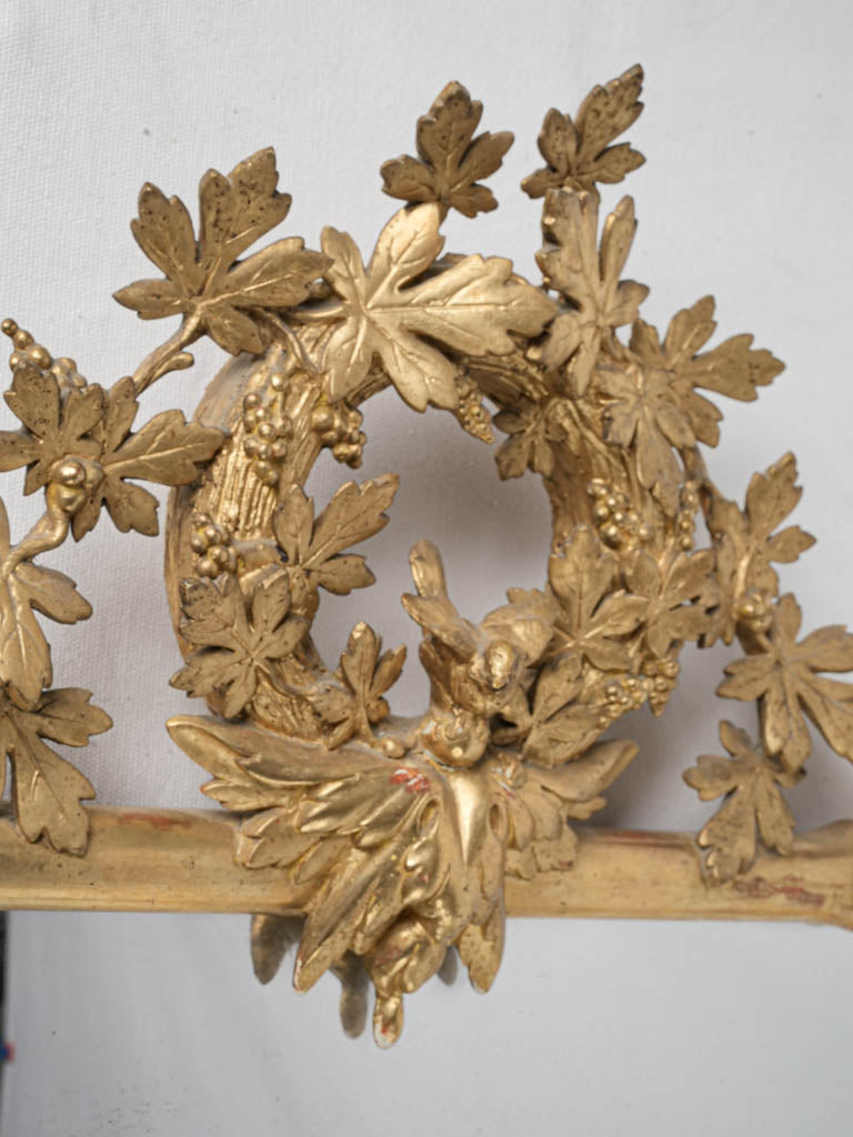 Antique, gilded, grapevine-adorned mirror