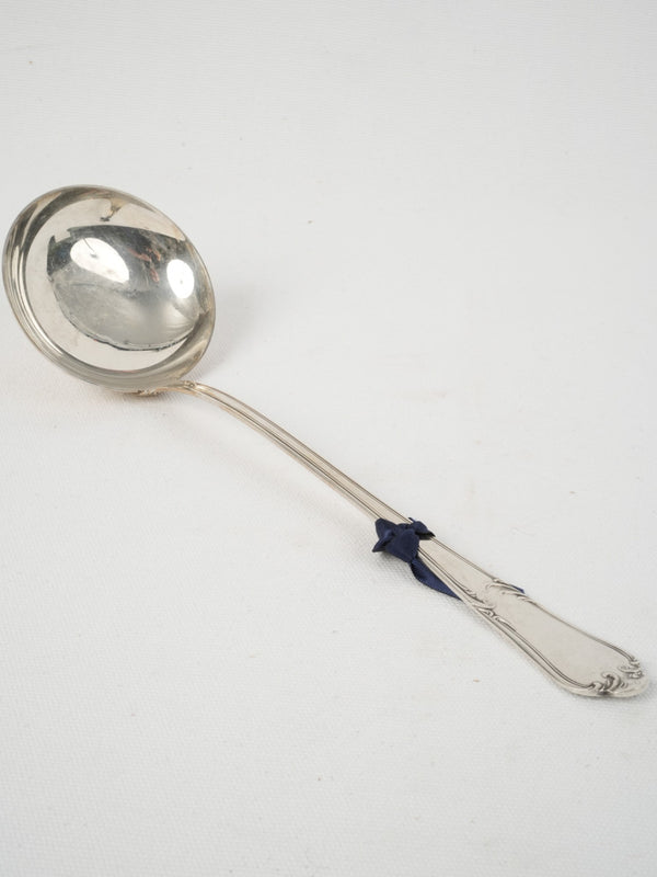 Intricate Rococo style soup ladle