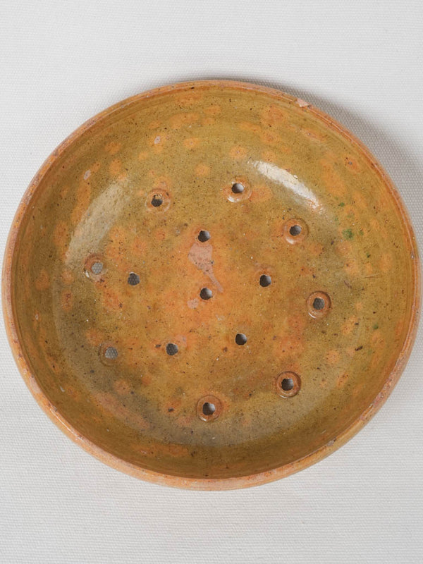 Antique ocher green sieve bowl