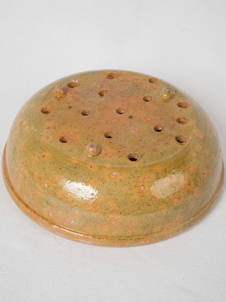 Charming ocher glazed sieve bowl