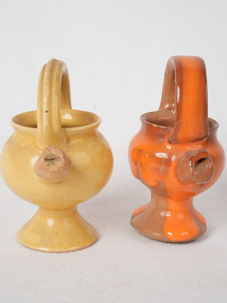 Aged orange & yellow terracotta whistles