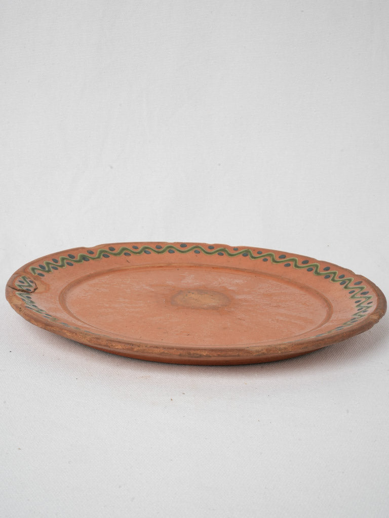 Glazed orange pottery platter