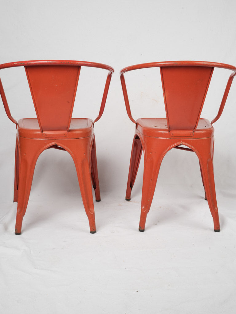 Red perforated seat metal armchairs