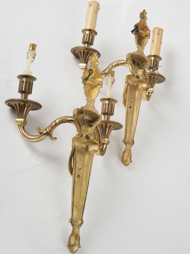 Elegant, aged, Louis XVI-style wall fixtures