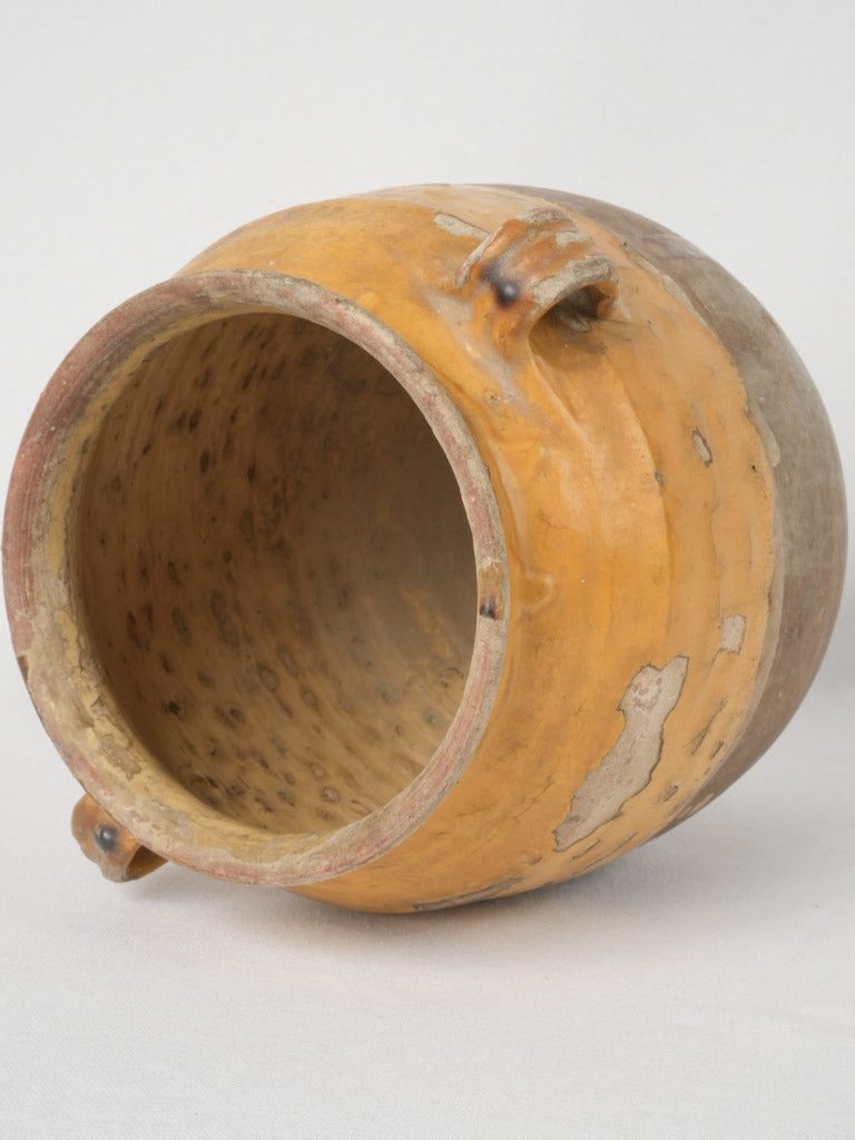 Patinated terracotta yellow-glazed confit pot