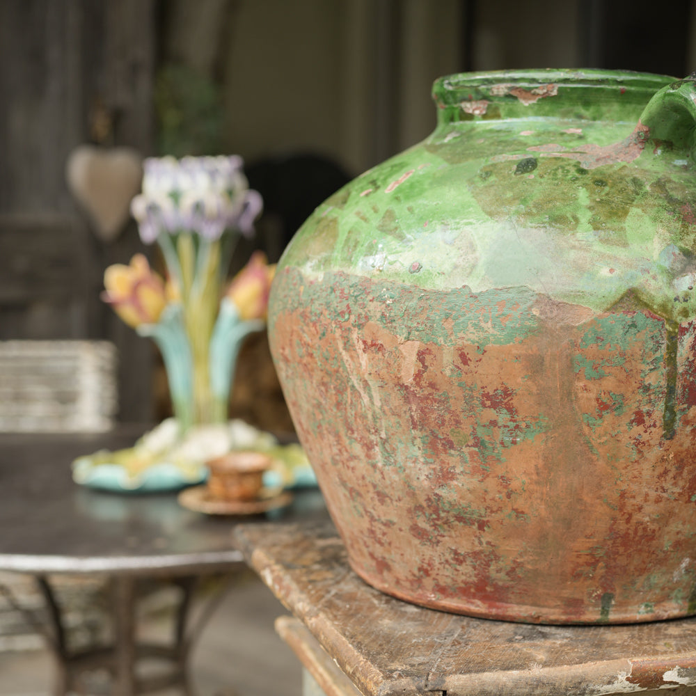 Large weathered green glazed pot