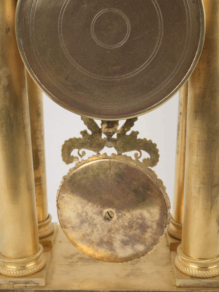 Aged Corinthian column adorned ormolu clock