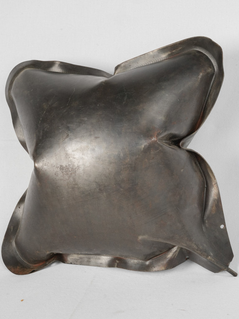 Patina-accented metal block-splitting pillow