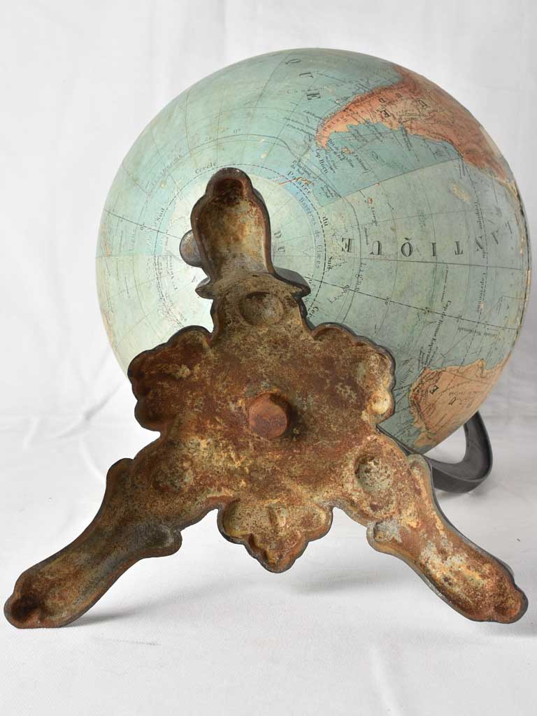 Vintage repaired globe on iron stand