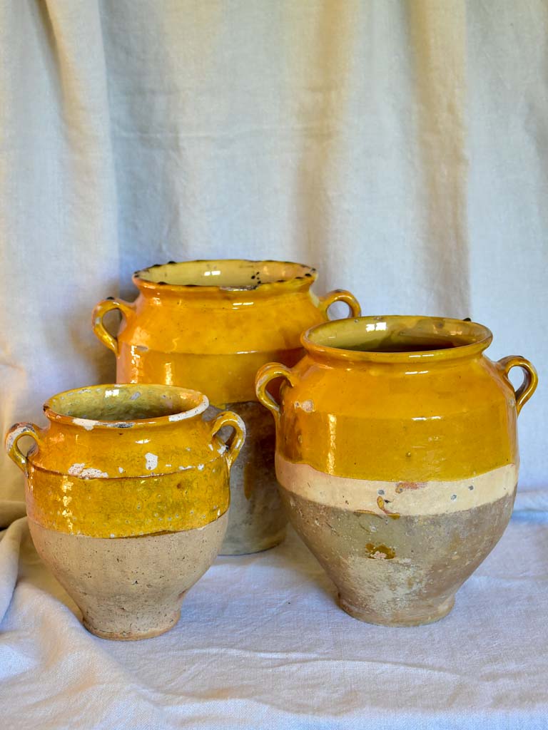 Collection of three antique French confit pots with ochre glaze