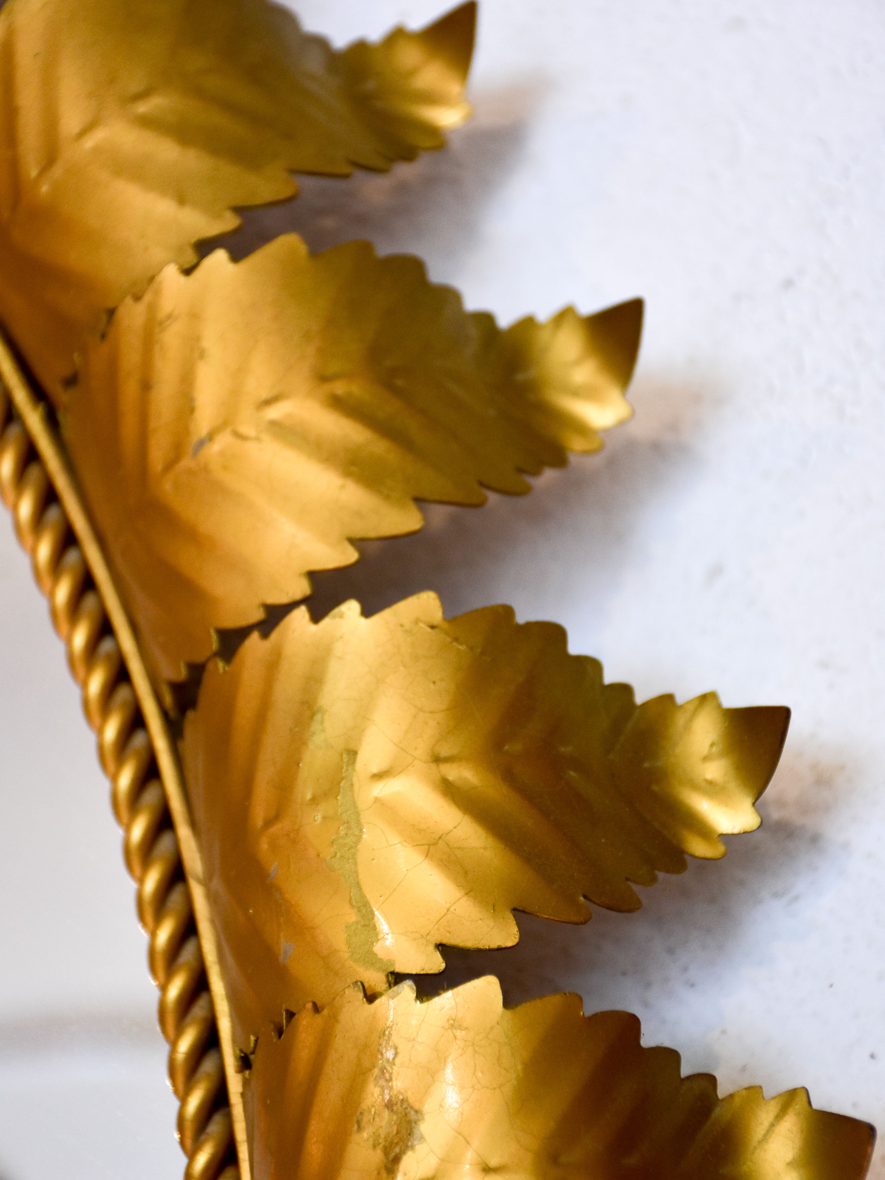 Oval sunburst mirror with sculptural leaf frame