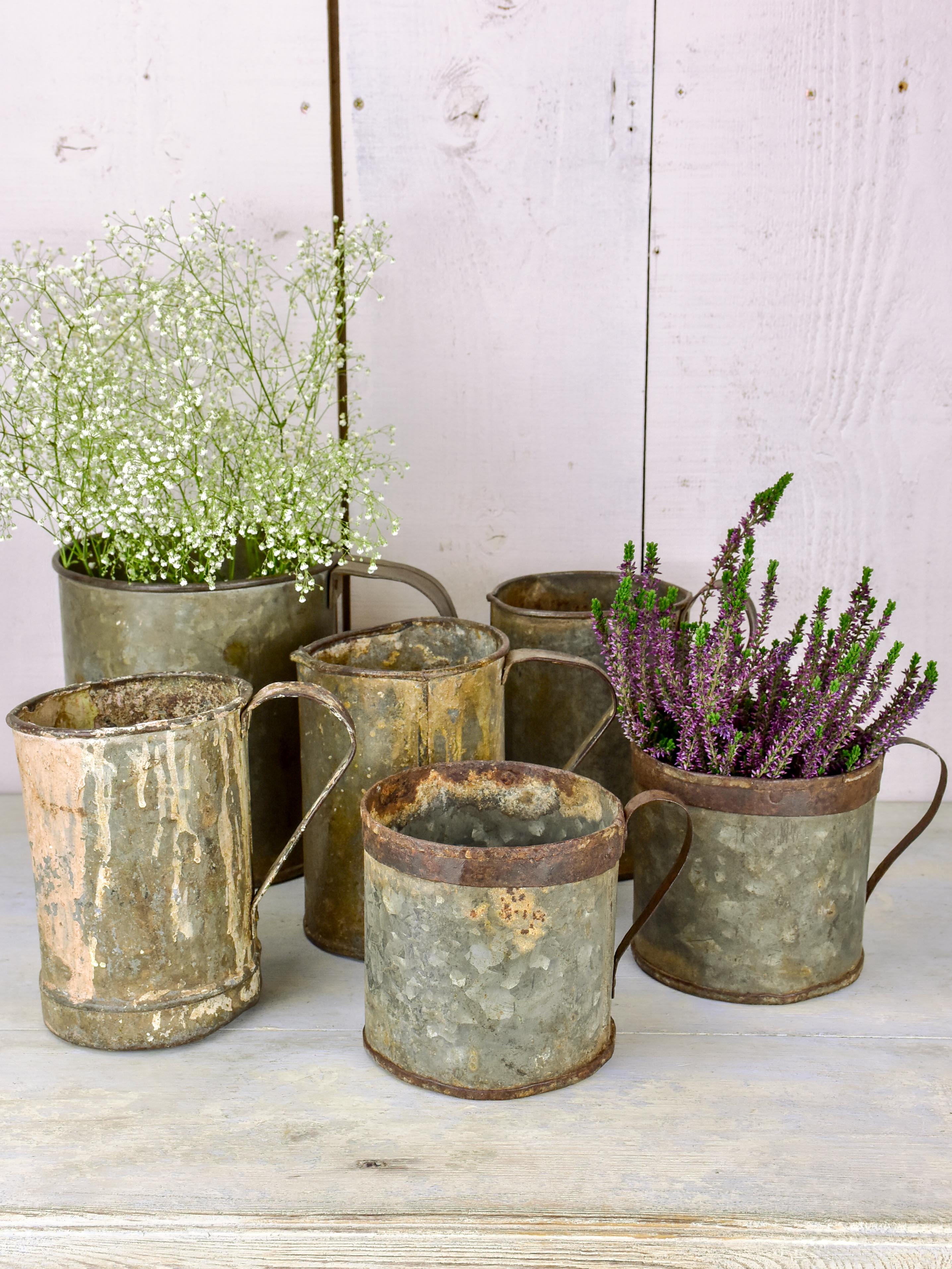 Collection of six antique zinc paint containers