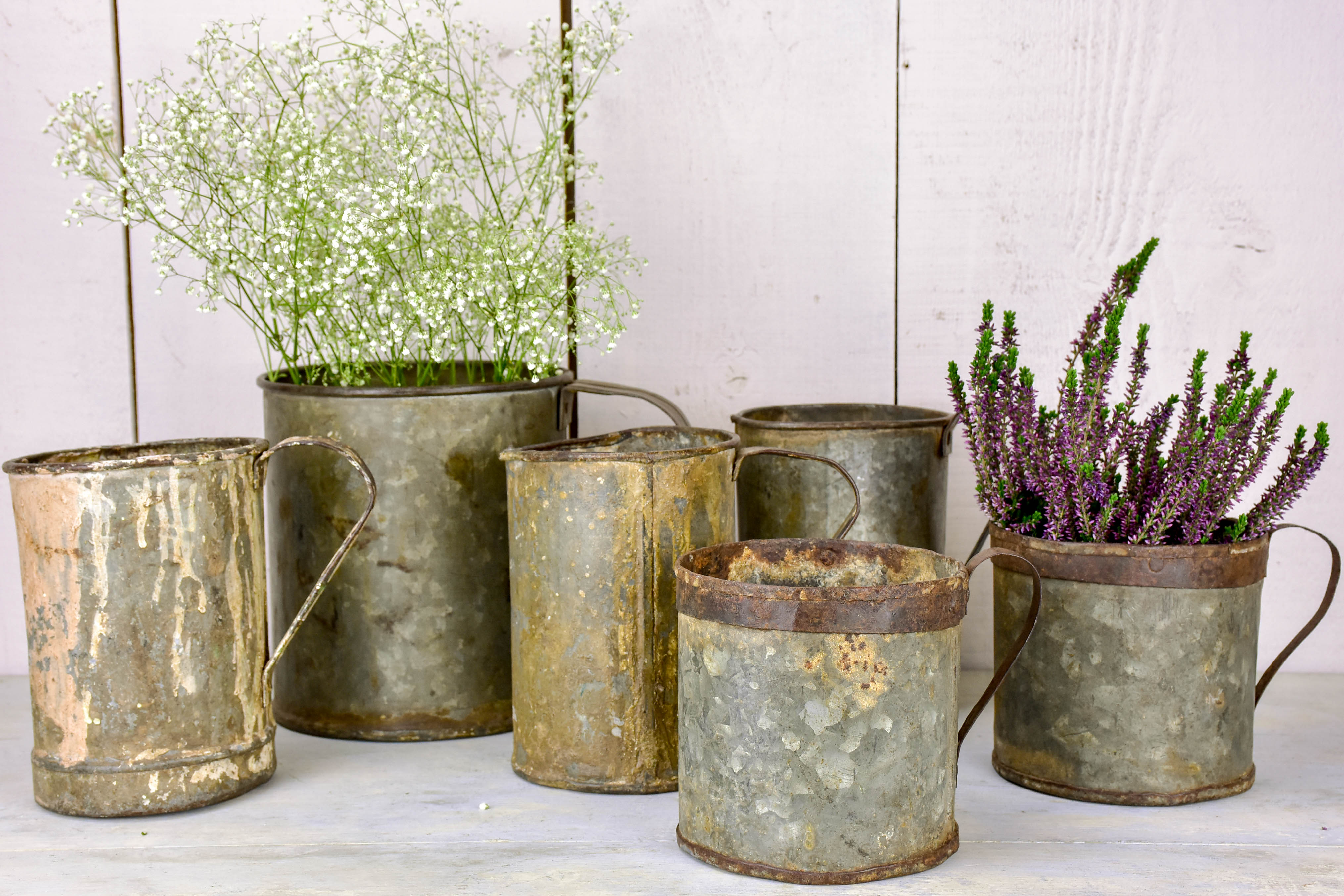 Collection of six antique zinc paint containers