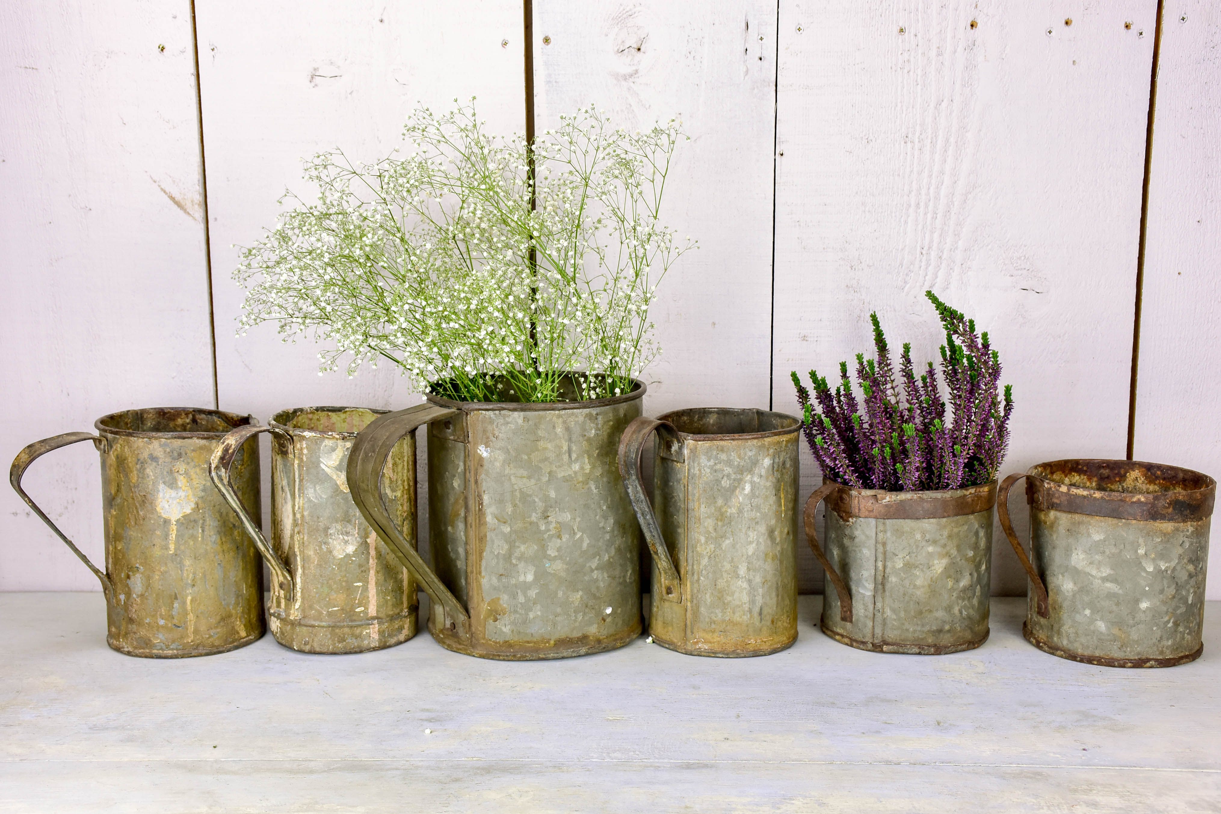 Collection of six antique zinc paint containers