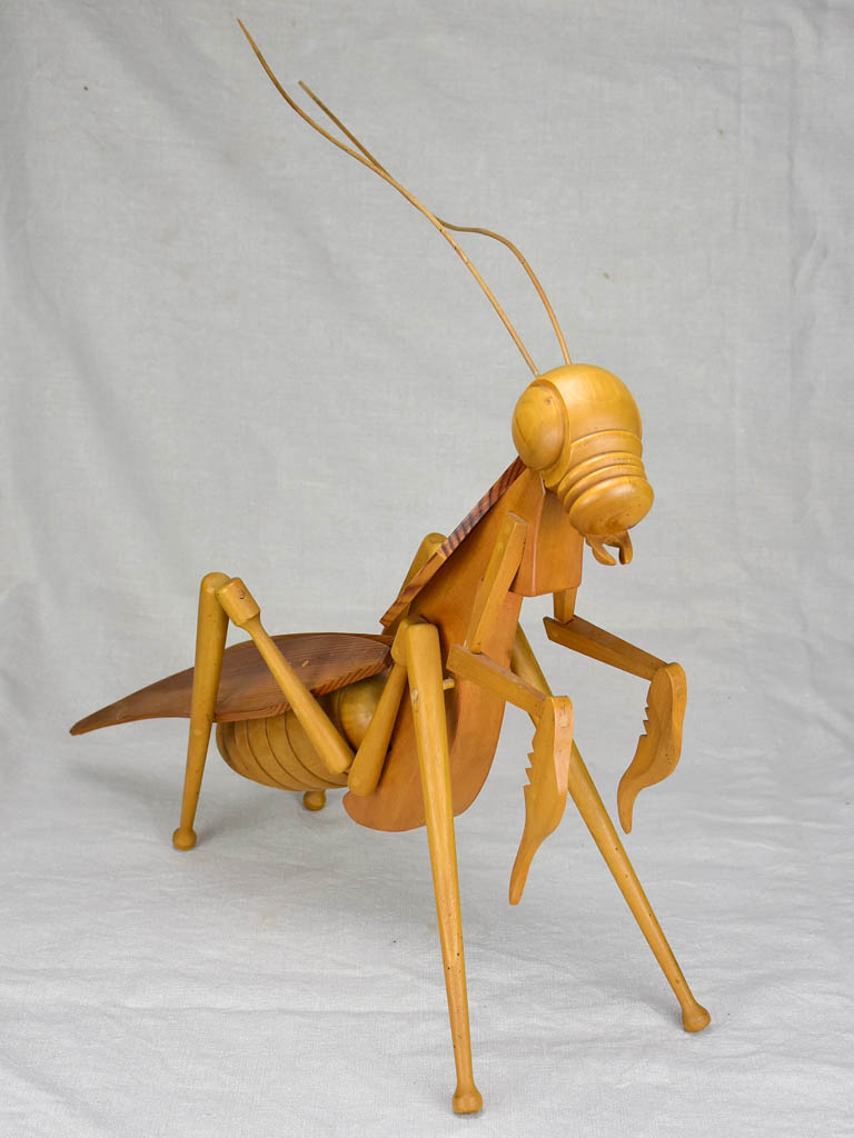 Vintage wooden sculpture of a huge praying mantis