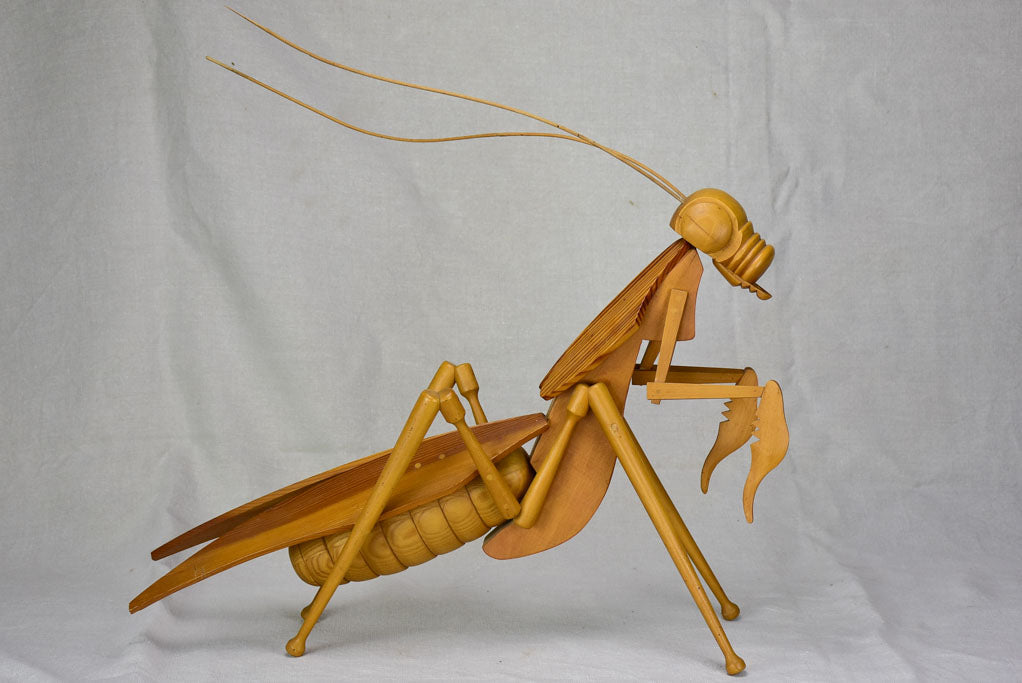 Vintage wooden sculpture of a huge praying mantis