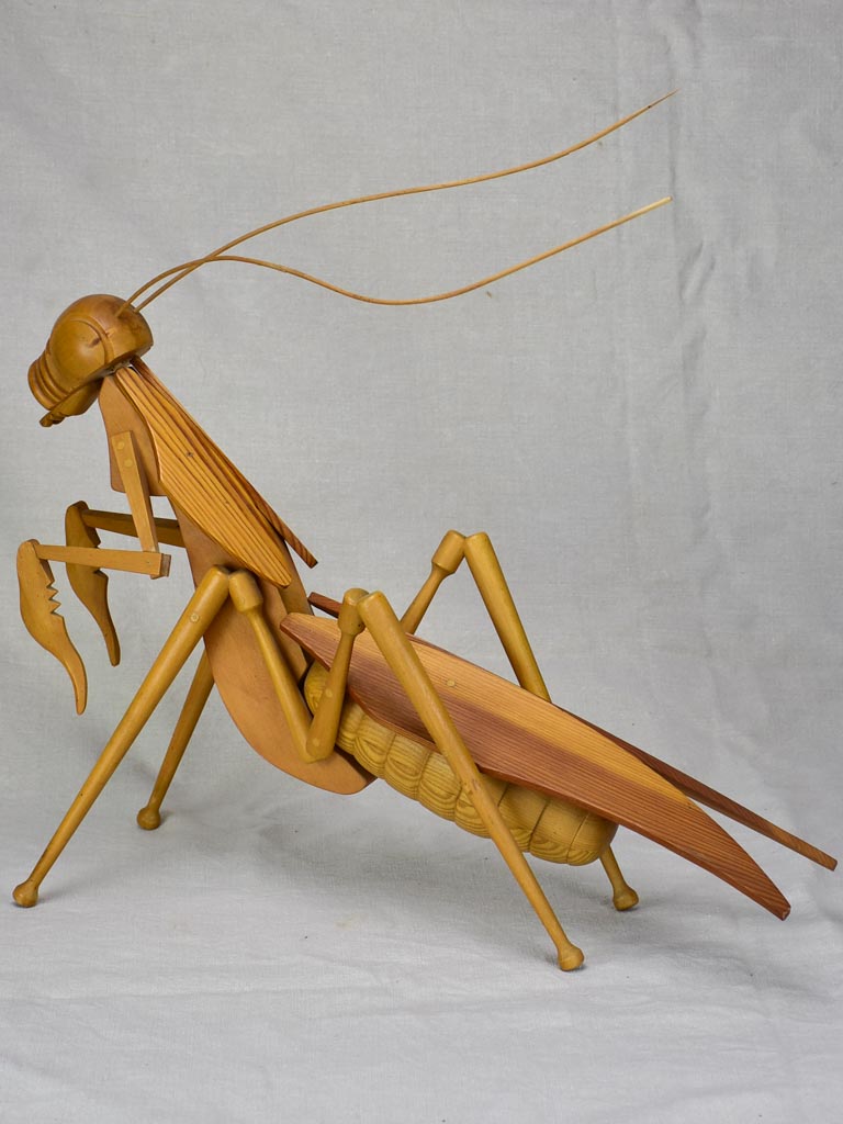 Vintage wooden sculpture of a huge praying mantis