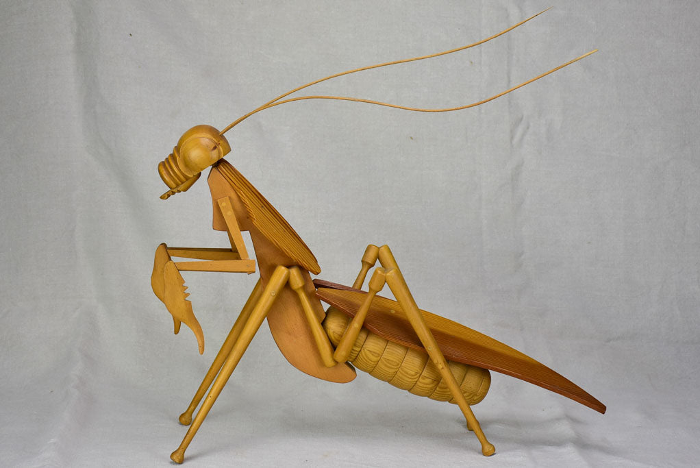 Vintage wooden sculpture of a huge praying mantis