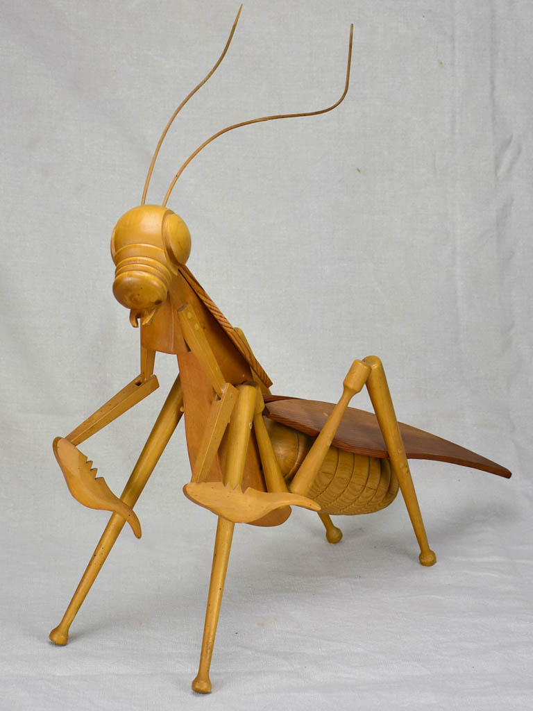 Vintage wooden sculpture of a huge praying mantis