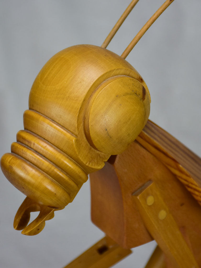 Vintage wooden sculpture of a huge praying mantis