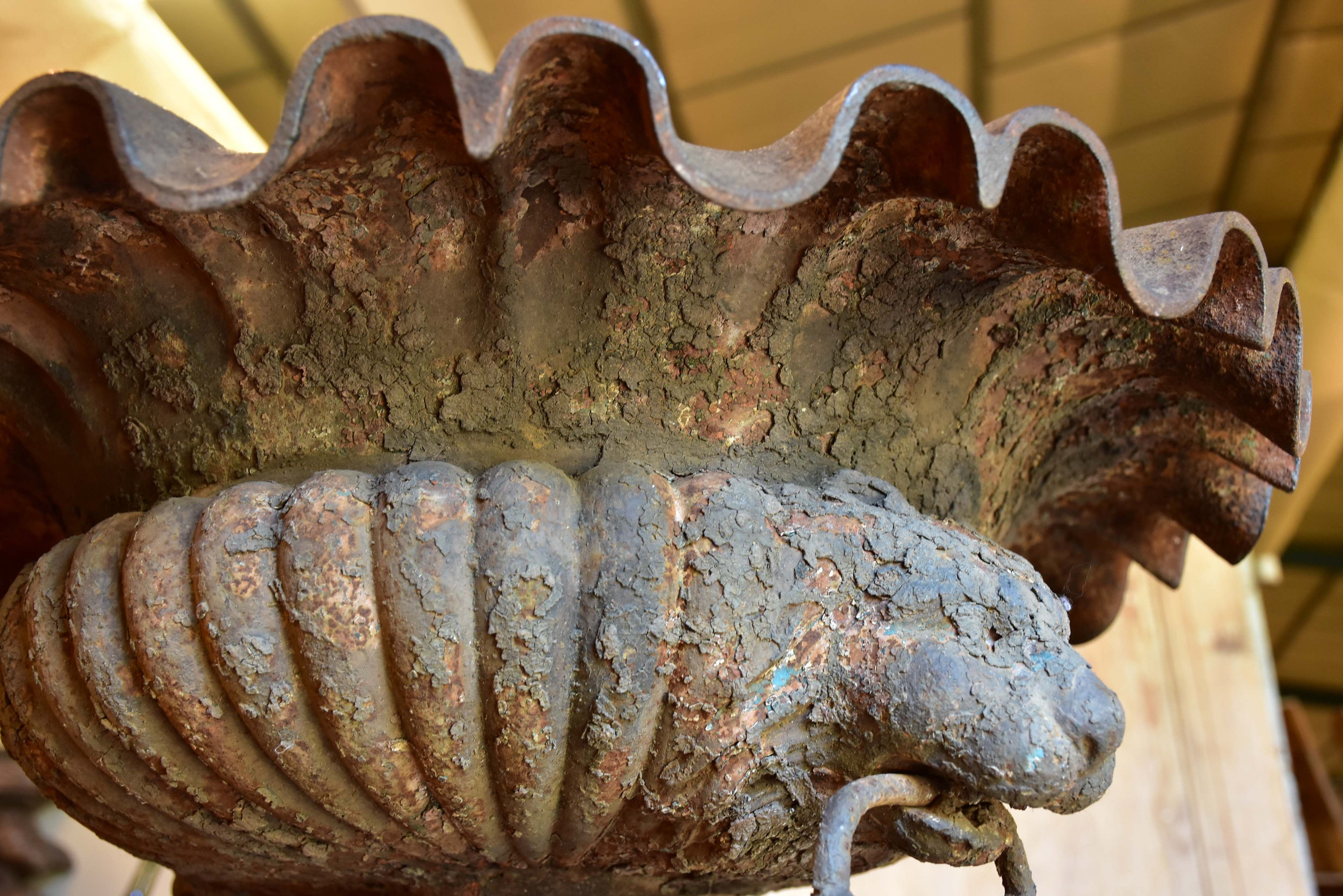 Large antique French urn with lions head handles and rippled edge