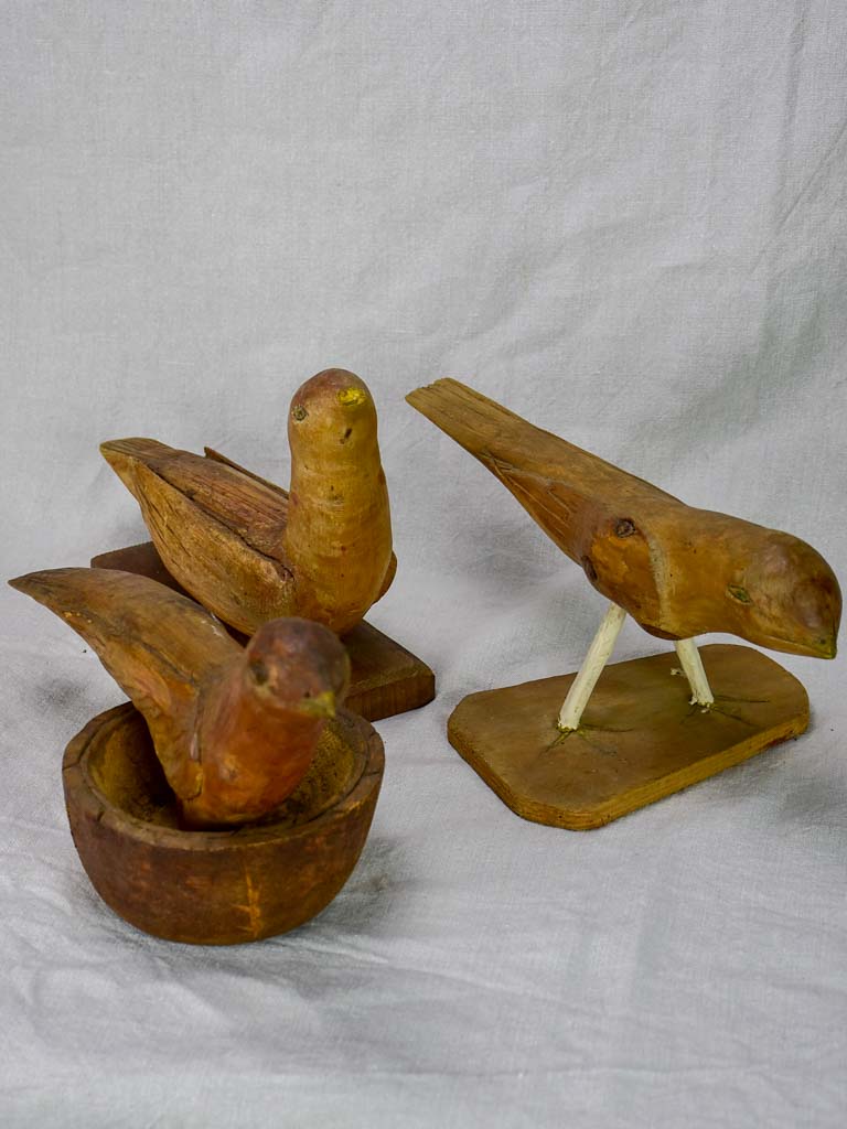 Three antique French primitive wooden sculptures of birds