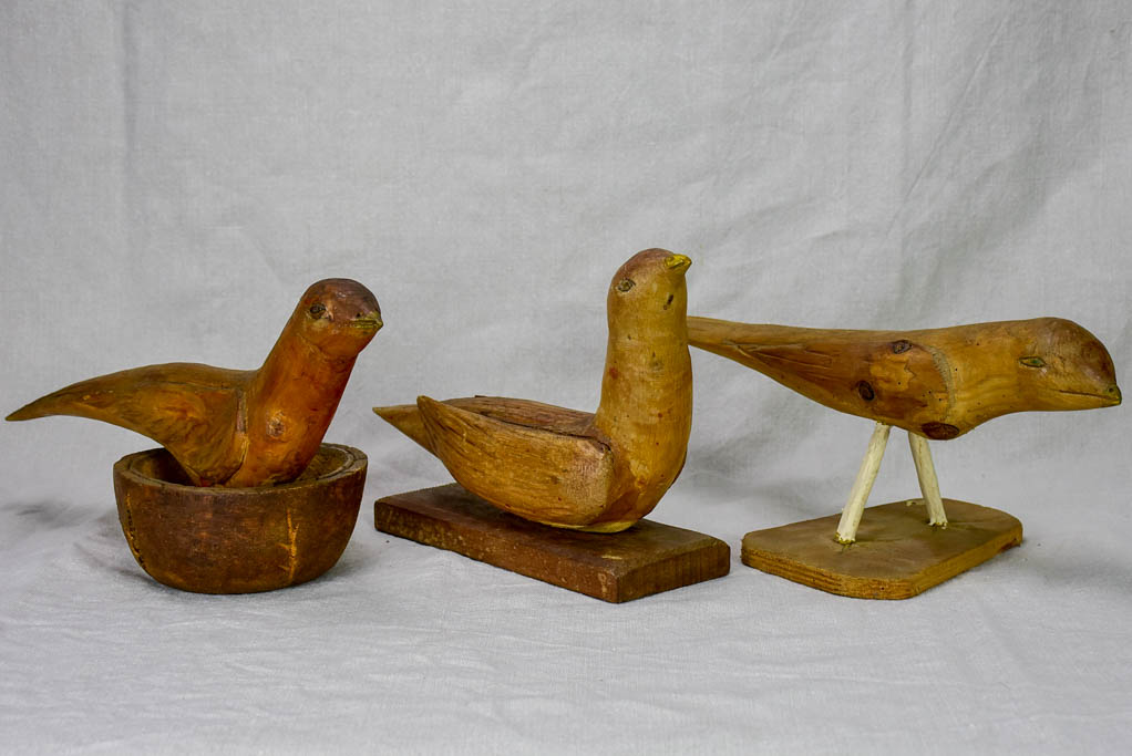 Three antique French primitive wooden sculptures of birds