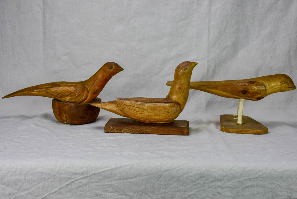 Three antique French primitive wooden sculptures of birds