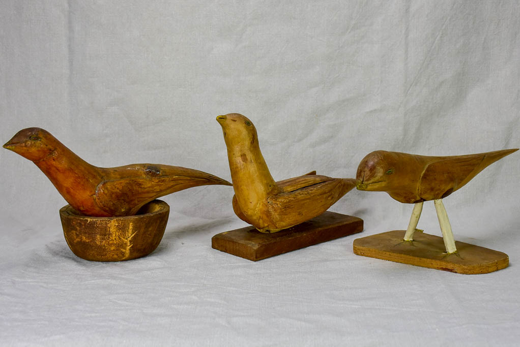 Three antique French primitive wooden sculptures of birds