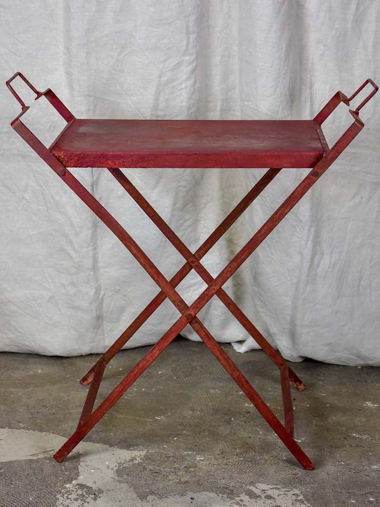 Red industrial French table made from salvaged materials