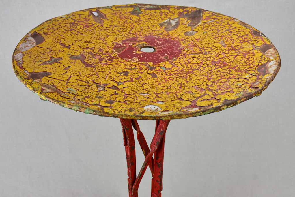 Early twentieth century bistro garden table with yellow and red patina