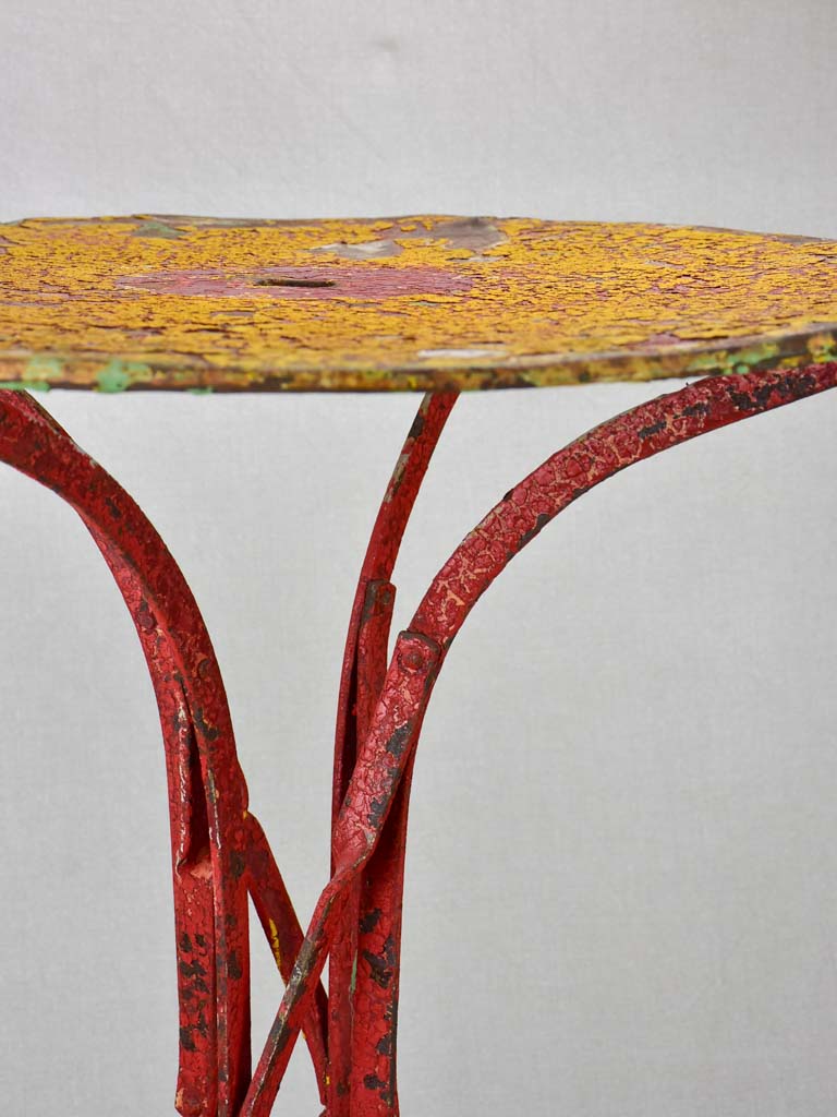 Early twentieth century bistro garden table with yellow and red patina